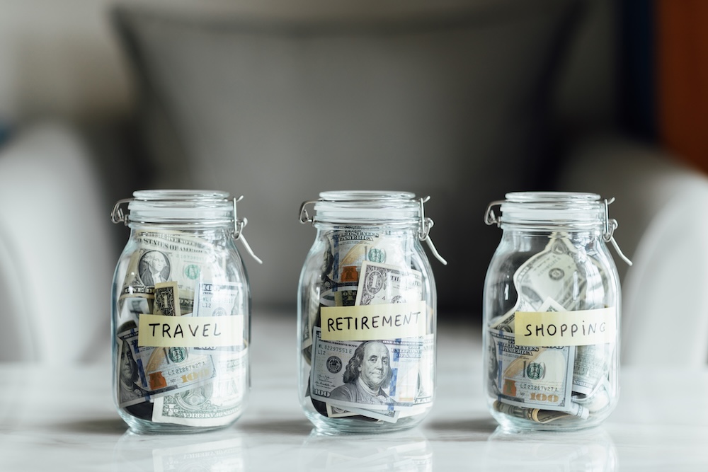 Three glass jars with cash money saved inside