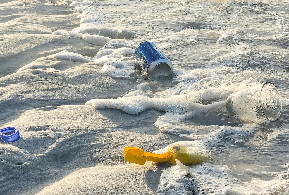 Trashing washing up on the beach shore