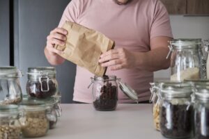 Man filling up a jar with just what he needs.