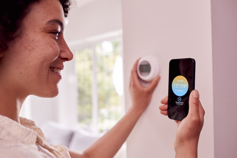 Woman configuring her smart thermostat app