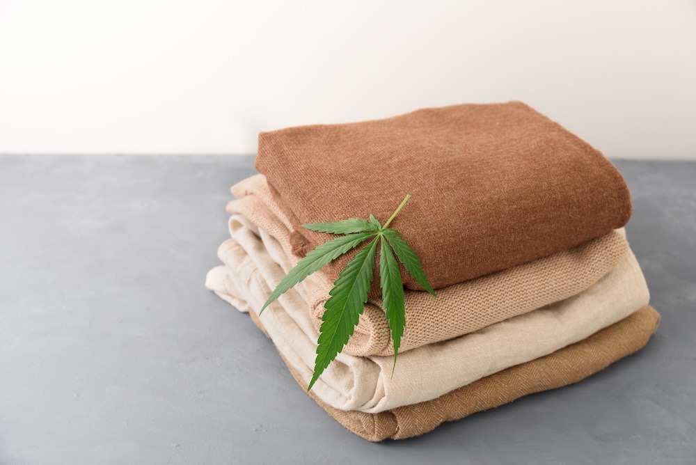 Nicely folded hemp clothes with a leaf on top