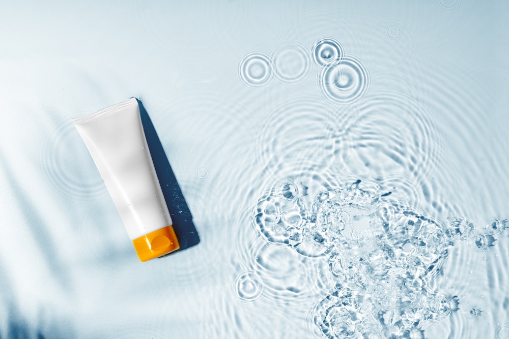 Sunscreen bottle floating in water