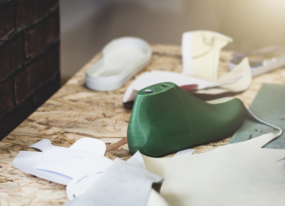 green boot made out of wood for shoe design