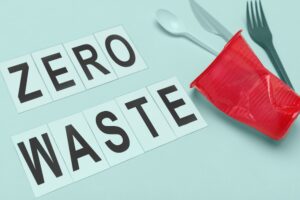Zero waste spelled out on a table with a plastic red cup