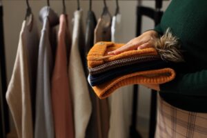 Woman returning folded clothing to store