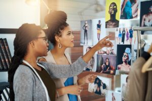 Two female designers collaborating on fashion trends