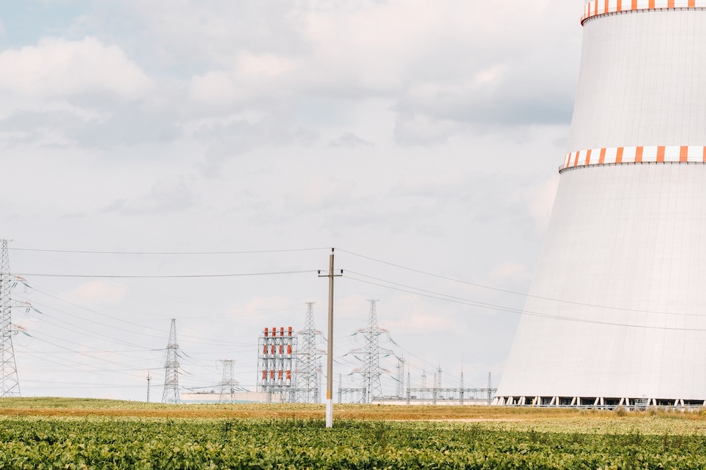 nuclear power plant closeup with fields and a blue sky