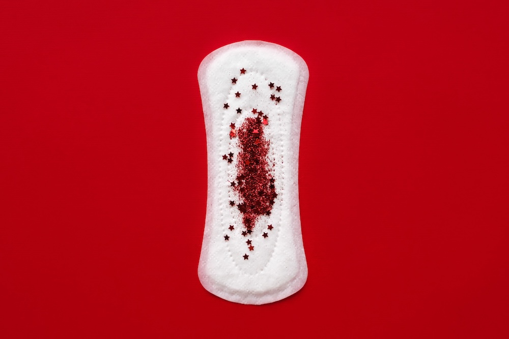 Menstruation cotton pad with red glitter stars