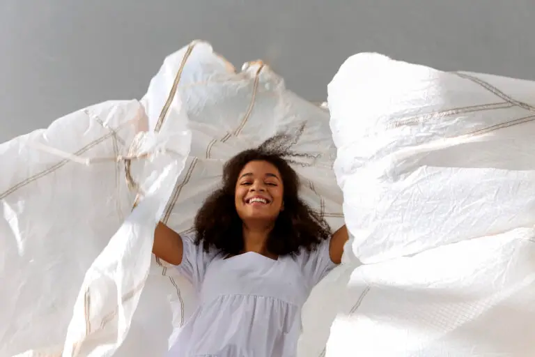 happy woman holding up a duvet cover