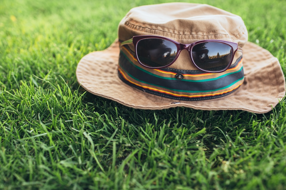 sun hat on ground with sunglasses