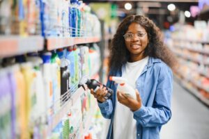 young woman reading labels in aisle