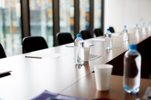 plastic bottled water and cup in a conference room