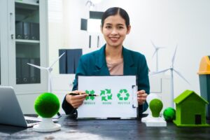 business woman holding a recycle sign in an office