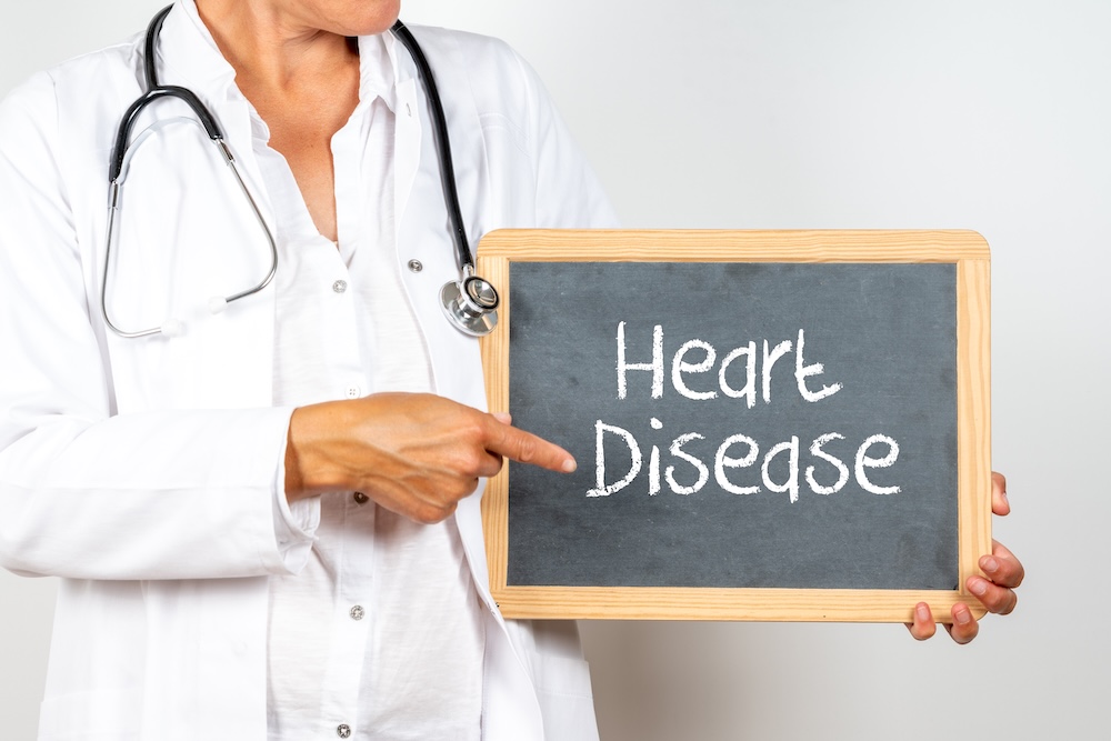 doctor holding sign says heart disease