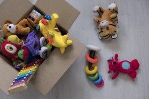 box of toys sitting on the floor packed for a toy swap