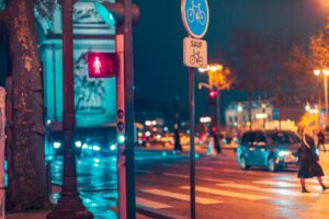 street lights with car lights on at night on the road