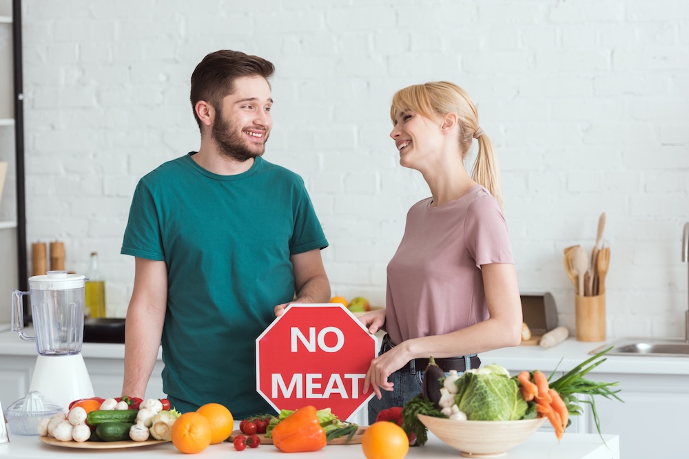 vegans with a sign that says no meat