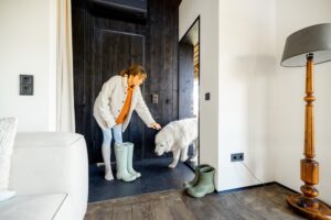 woman coming in through the entryway from walking her dog
