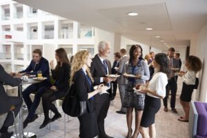 networking conference event with people standing around with disposable dishware