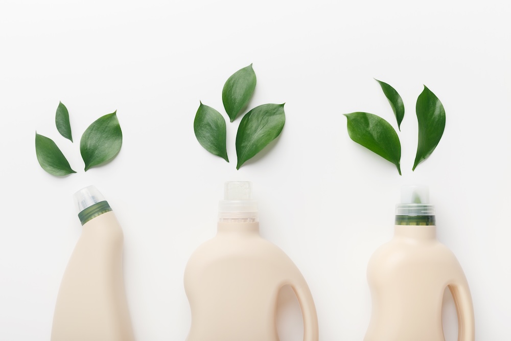 three types of cleaning bottles with leaves coming out of the top