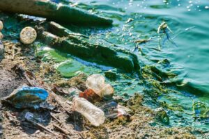garbage in sand floating out to the ocean