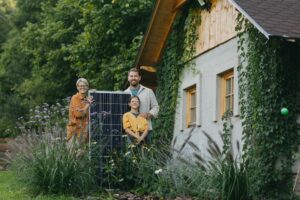 family standing by off grid house with solar panels in hand