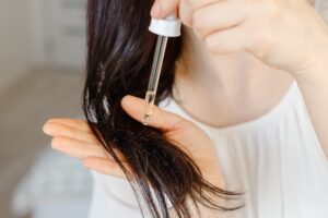 woman using natural oils on ends of hair