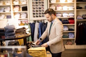 business man browsing through clothing store