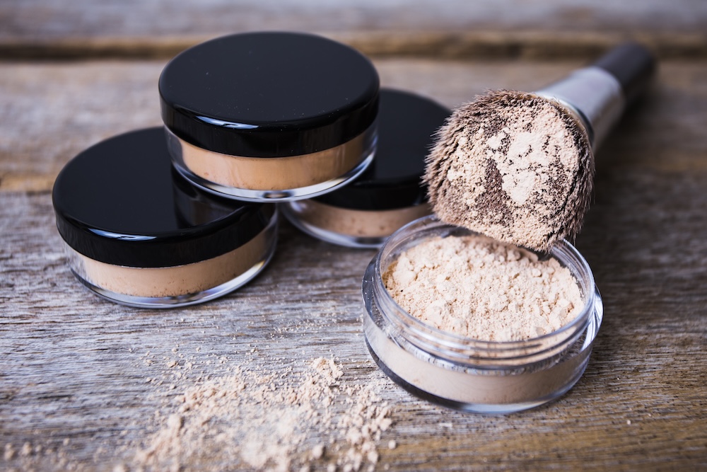 mineral powders with a brush with dusted mica on the table