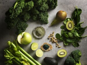 healthy leafy greens and fruit on a table