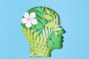 head cut out of paper with flowers and leaves inside