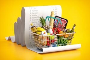 groceries in a cart with a receipt of all the expenses