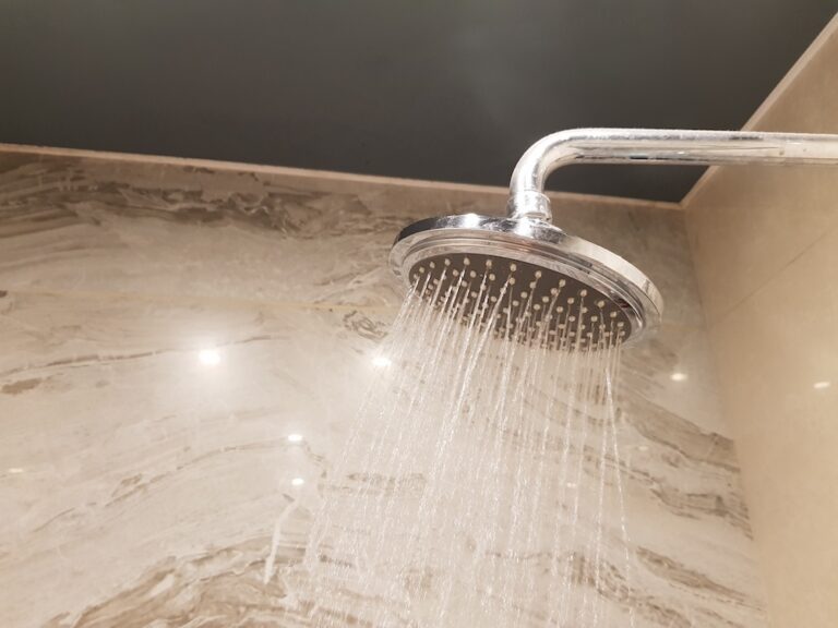 metalic shower head with water pouring out