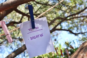 sign on a clothes line saying to do with the word breathe