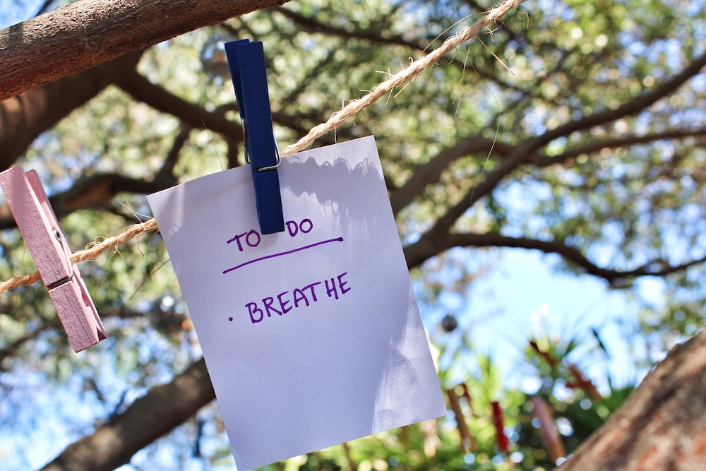sign on a clothes line saying to do with the word breathe