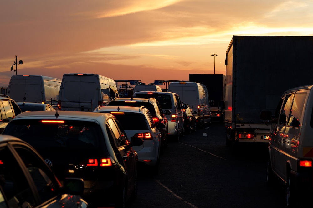 traffic jam with cars sitting and wasting fuel in late evening