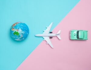 earth on left airplane in the center and car on the right