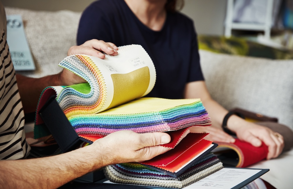 two people looking through fabric options