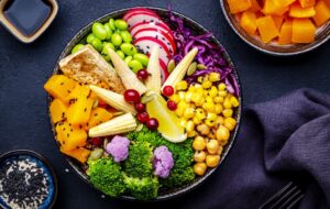 vegan buddha bowl on a table with vegetable dishes