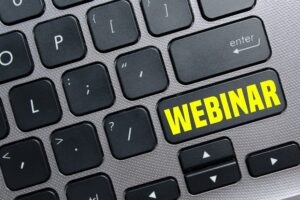 digital events on a keyboard that says webinar in yellow