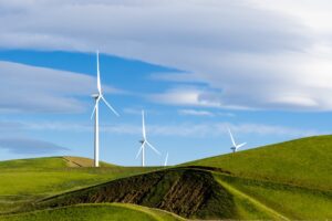 wind turbines on hills with blue sky