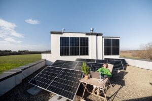 woman sitting out near her solar panels