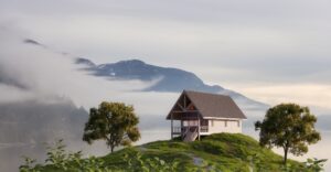 small cabin on top of a hill