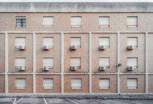 building with many hvac systems sitting outside windows