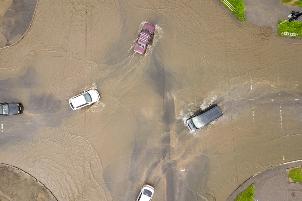 cars driving through flooded road