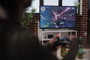 Person playing video games on a flat screen tv