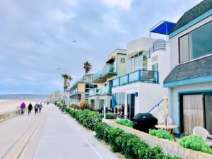 beachfront property with people walking by