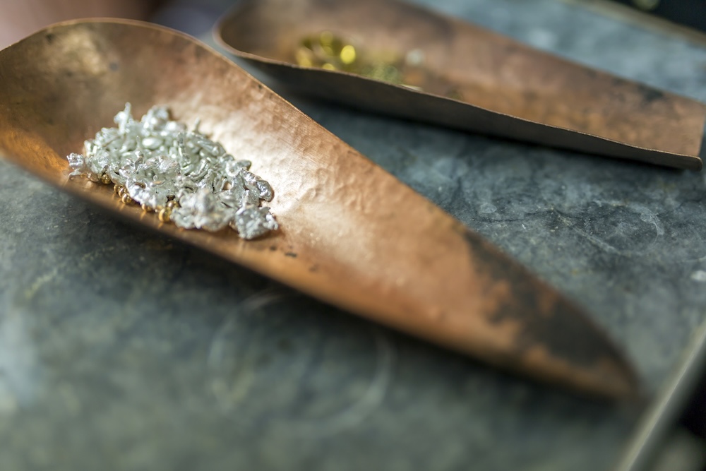 Mined metals and gems in copper scoops