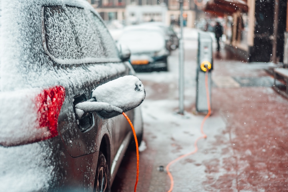 EV car charging during winter snow storm