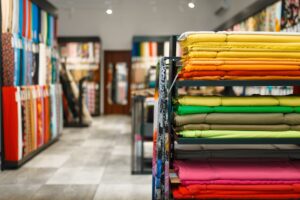 textile shop with fabric folded on shelves